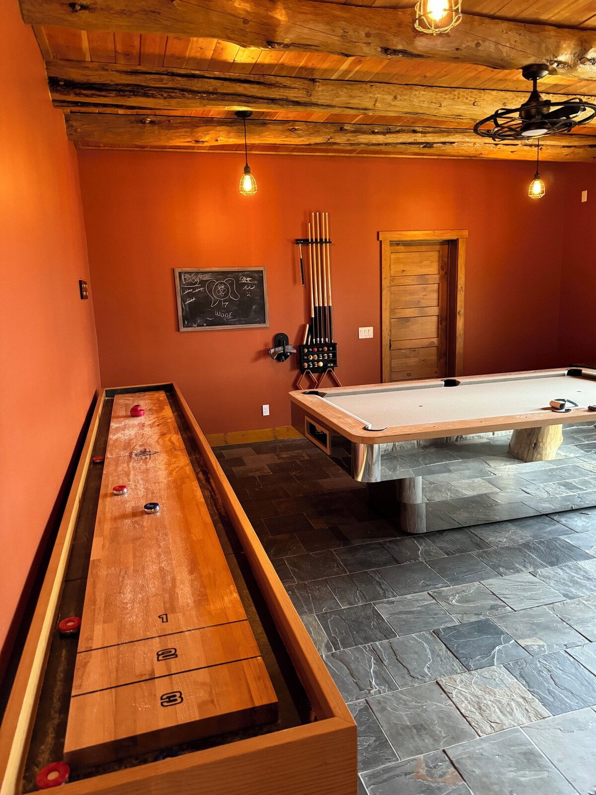 Game room with shuffleboard, pool table and exercise equipment