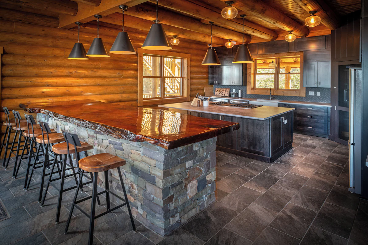 Main kitchen with stone-front island and timber bar